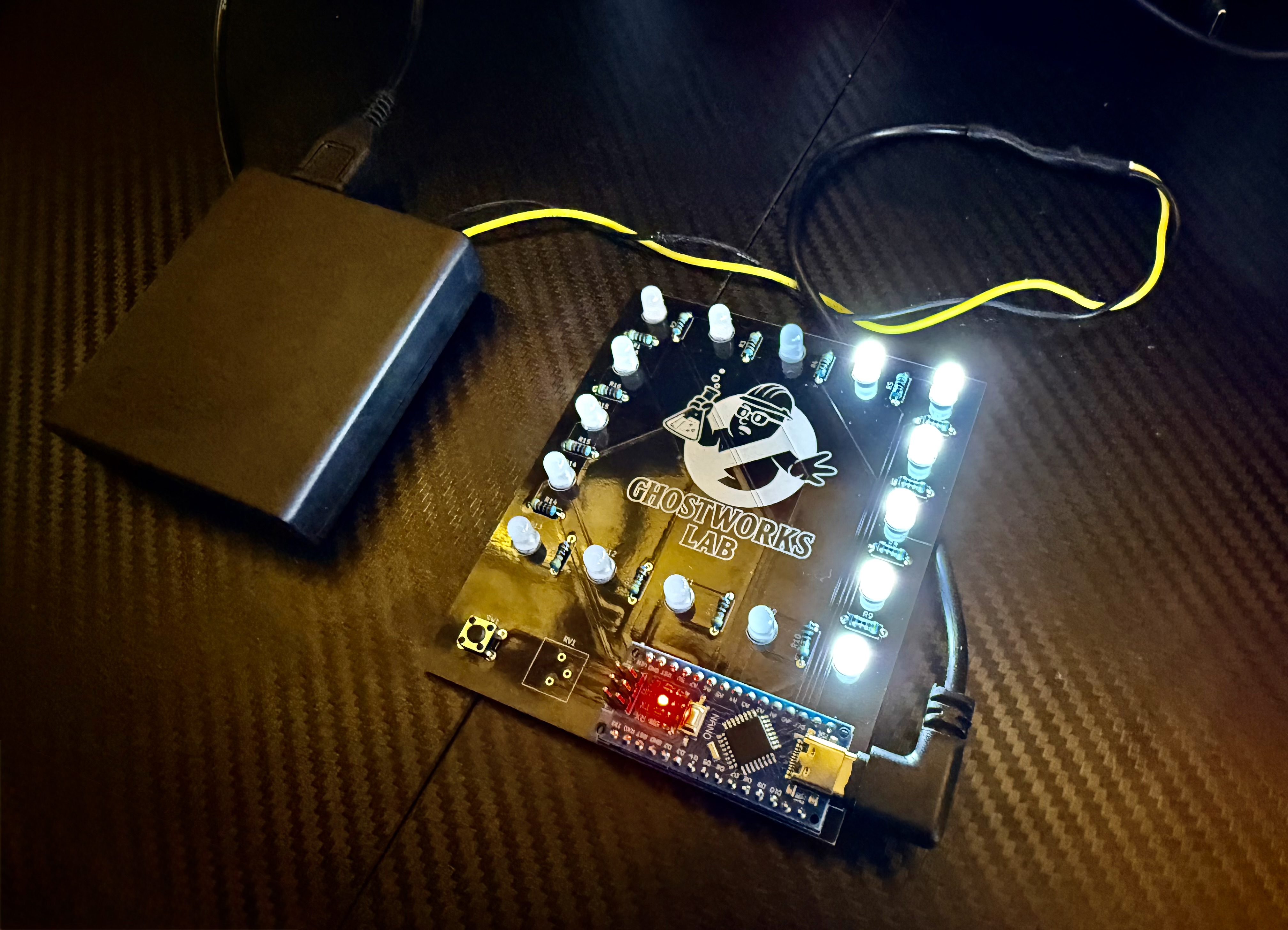 Black Pocket Gizmo board with white LEDs lit